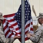 Situazione in Afghanistan, PRC – SE: Paesi responsabili di 20 anni di guerra pongano fine a violenza per costruire pace e salvare chi fugge dai “talebani” U.S. Marines lower their flag during a handover ceremony, as the last U.S. Marines unit and British combat troops end their Afghan operations, in Helmand