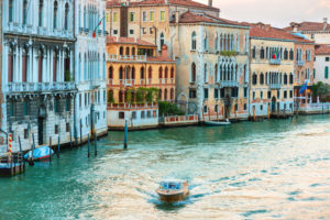 Trip boat on Grand Canal at evening in Venice, Italy