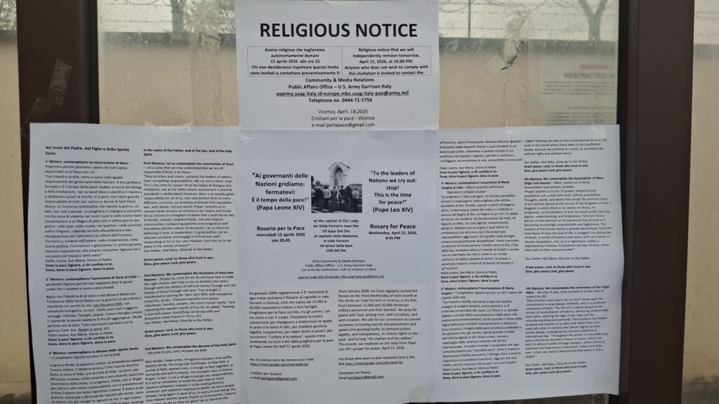 Testo del Rosario con intenzioni di papa Leone affisso per il 15.04.2026 alla fermata del bus alla Del Din, the text of the rosary posted from Cristiani della Pace at the bus stop at the Del Din barrack