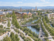 Masterplan Vicenza 2030: cosa prevede per case, quartieri, lavoro e spazi verdi Masterplan Vicenza 2030: illustrazione contemporanea con mercato, edifici industriali recuperati, parco fluviale e strutture sanitarie.